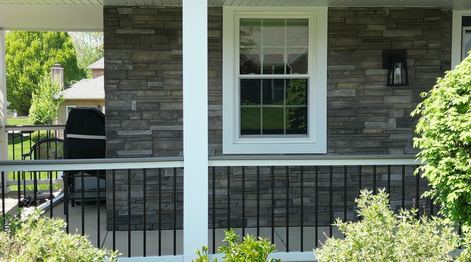 Exterior house detail with window, trim, and stone